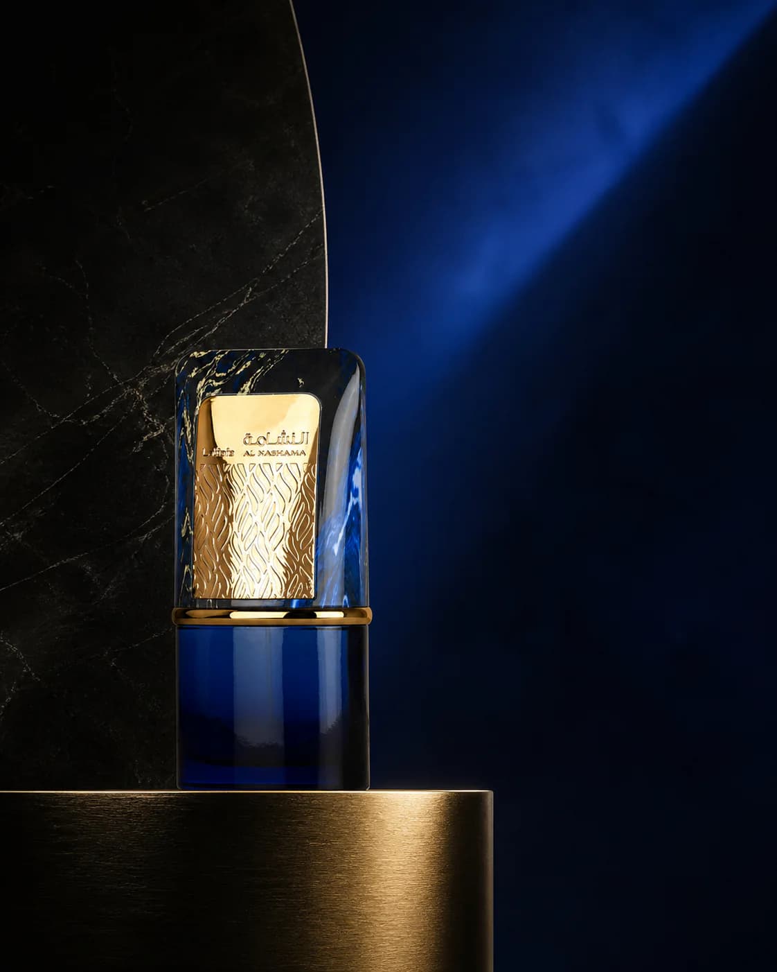Lattafa Al Nashama blue and gold bottle in deep evening light